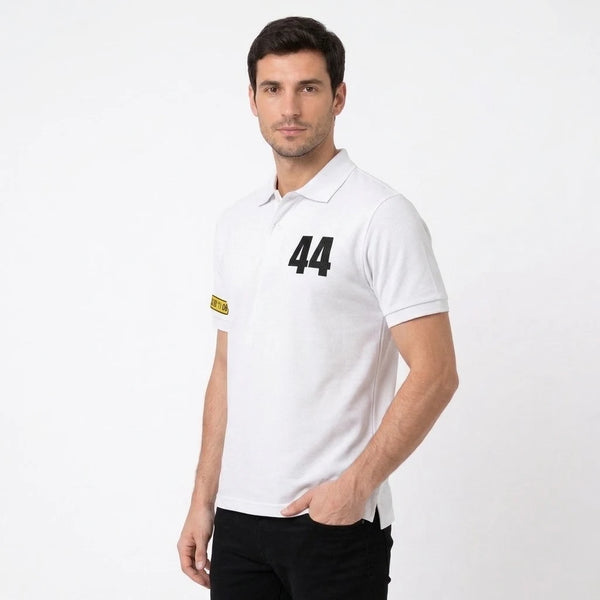 Homme portant le polo blanc Lewis Hamilton, cadré en buste, 44 et plaque de manche visibles
